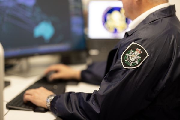 Uniformed officer using computer