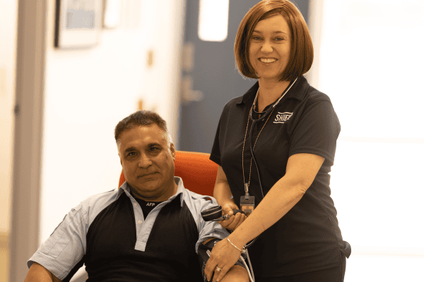An AFP nurse taking the blood pressure of a police officer