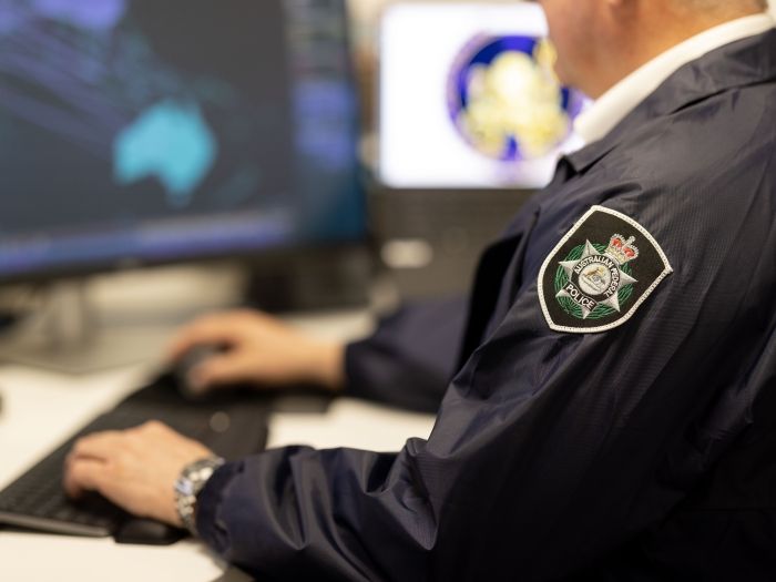 Uniformed officer using computer