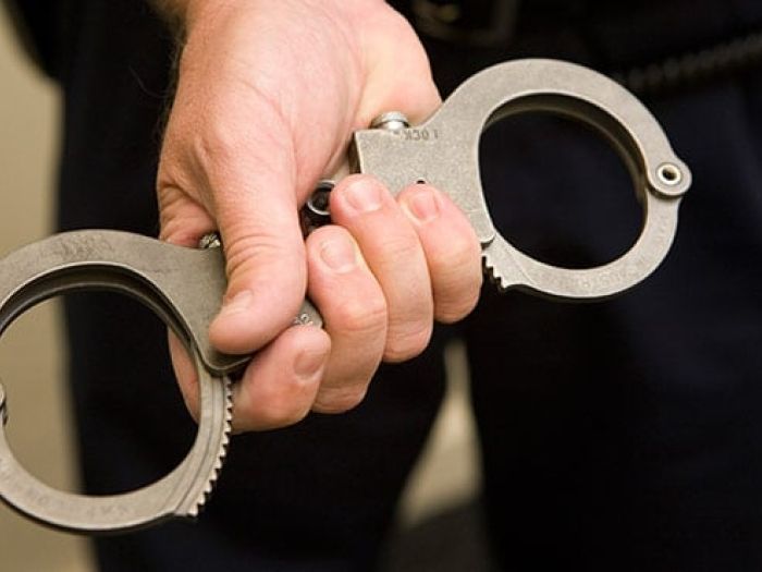 hand holding handcuffs