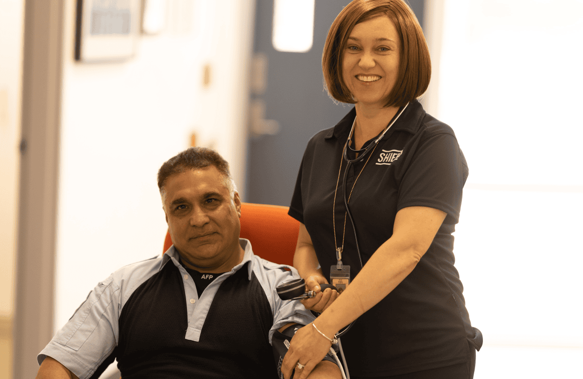 An AFP nurse taking the blood pressure of a police officer
