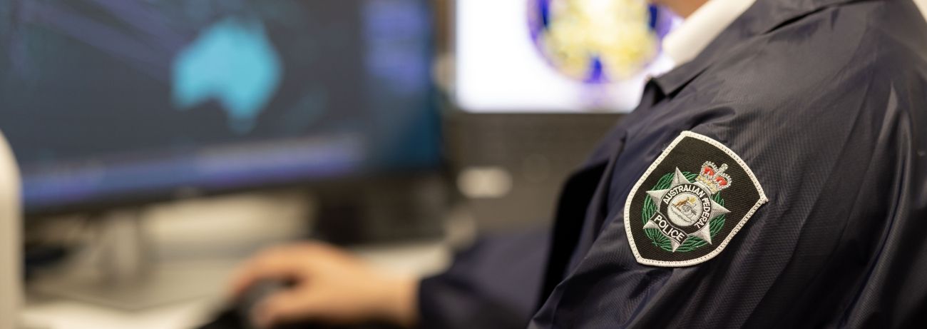 AFP investigator at a computer