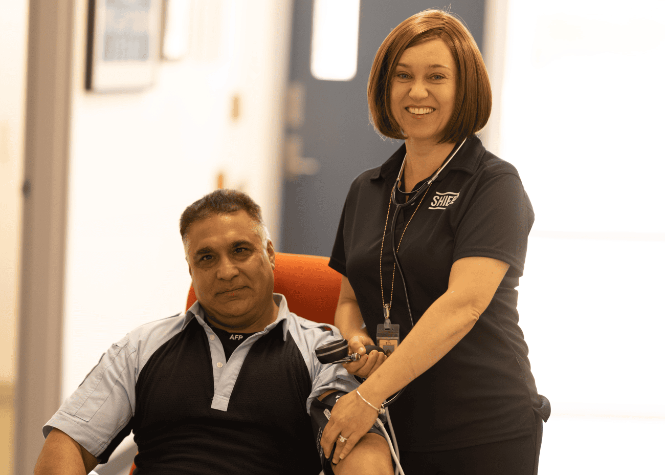 An AFP nurse taking the blood pressure of a police officer