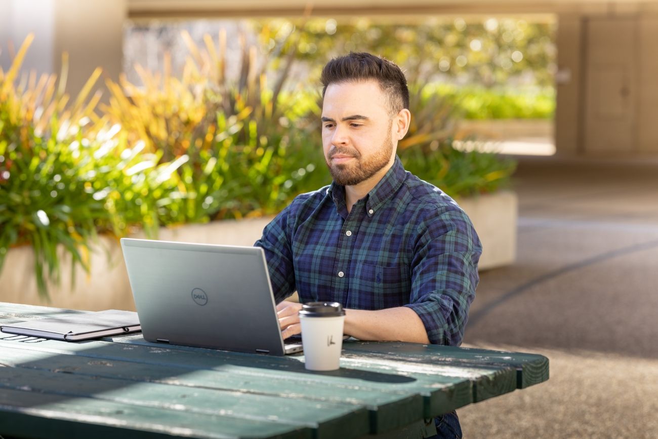 AFP suupport staff member sitting at desk with computer